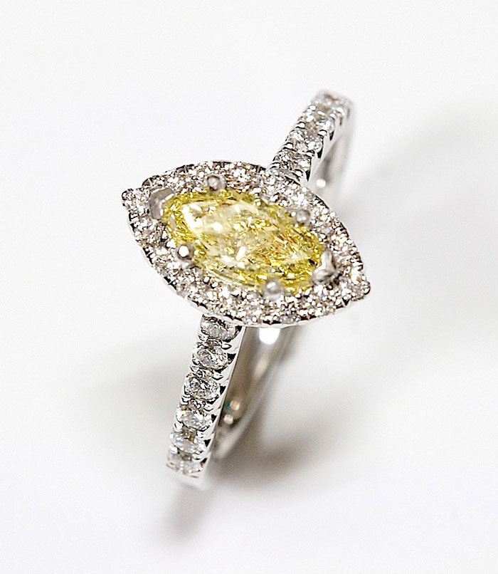 GIA Certified  Fancy Yellow 0.75ct marquise Diamond Ring with 0.65 carat small rounds in platinum.